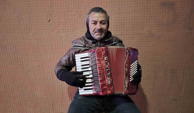 Yağmur, soğuk demeden enstrümanını çalıyor